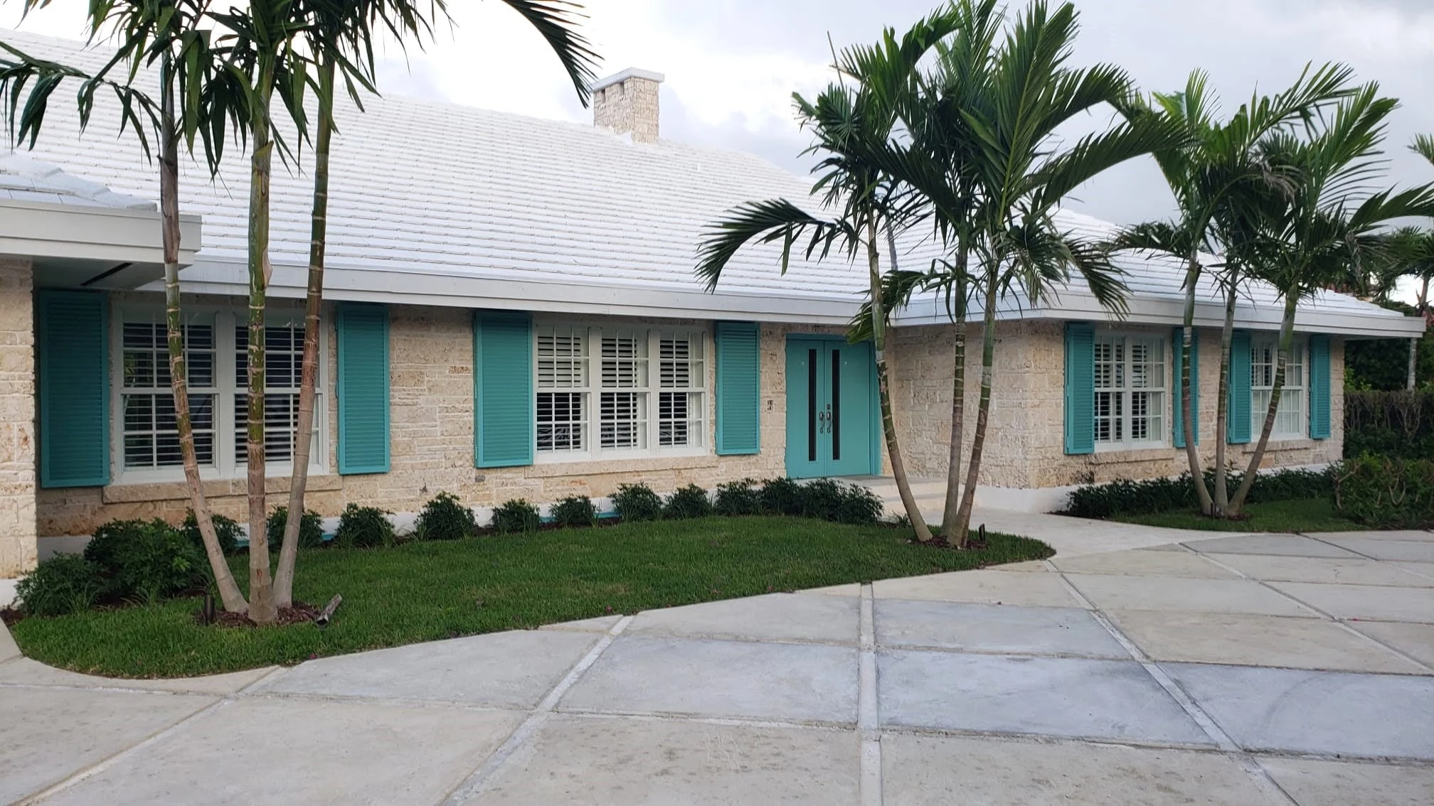 Bahamian home with turquoise colonial shutters